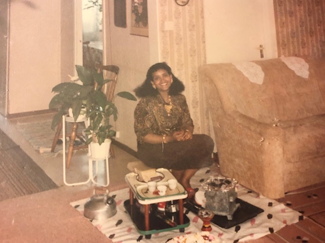 A picture of a woman sitting and performing a coffee ceremony