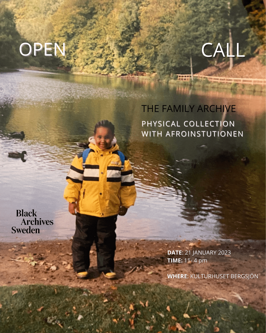 An image of black child in a bright yellow jacket, standing infront of a lake.