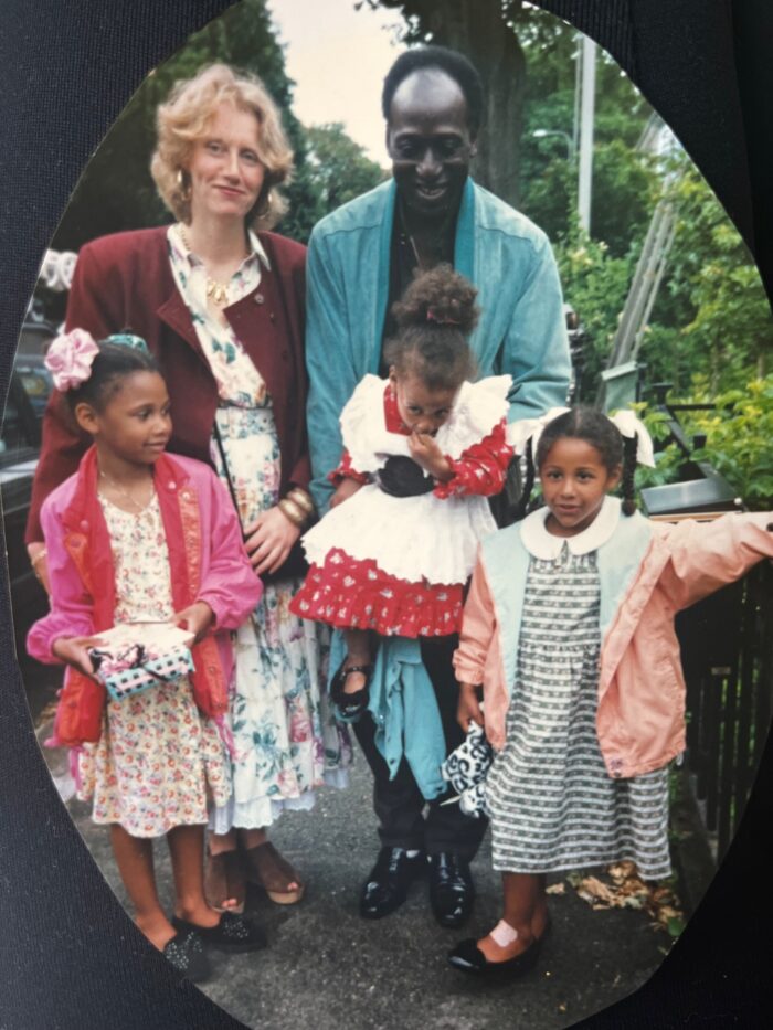 A picture of a mixed family, with a mum, dad and 3 girls.
