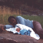 An image of a black dad and his newborn baby